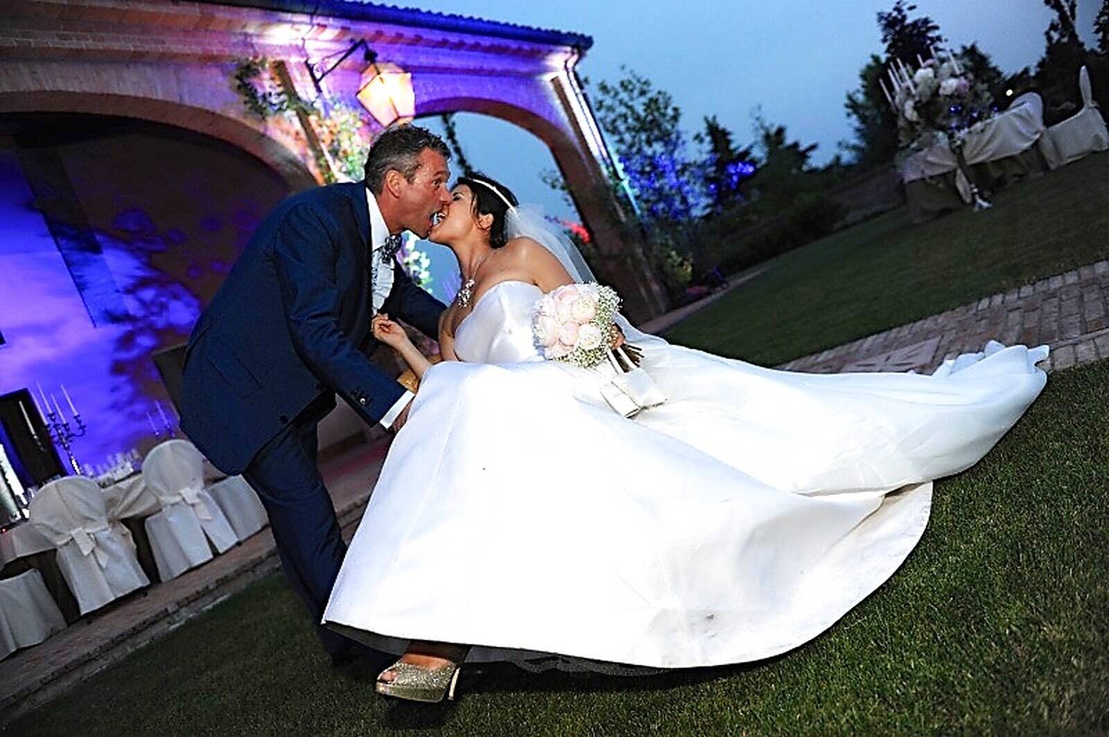 Emilia ed Hervé si baciano nel giardino di Romito, la sera del loro matrimonio